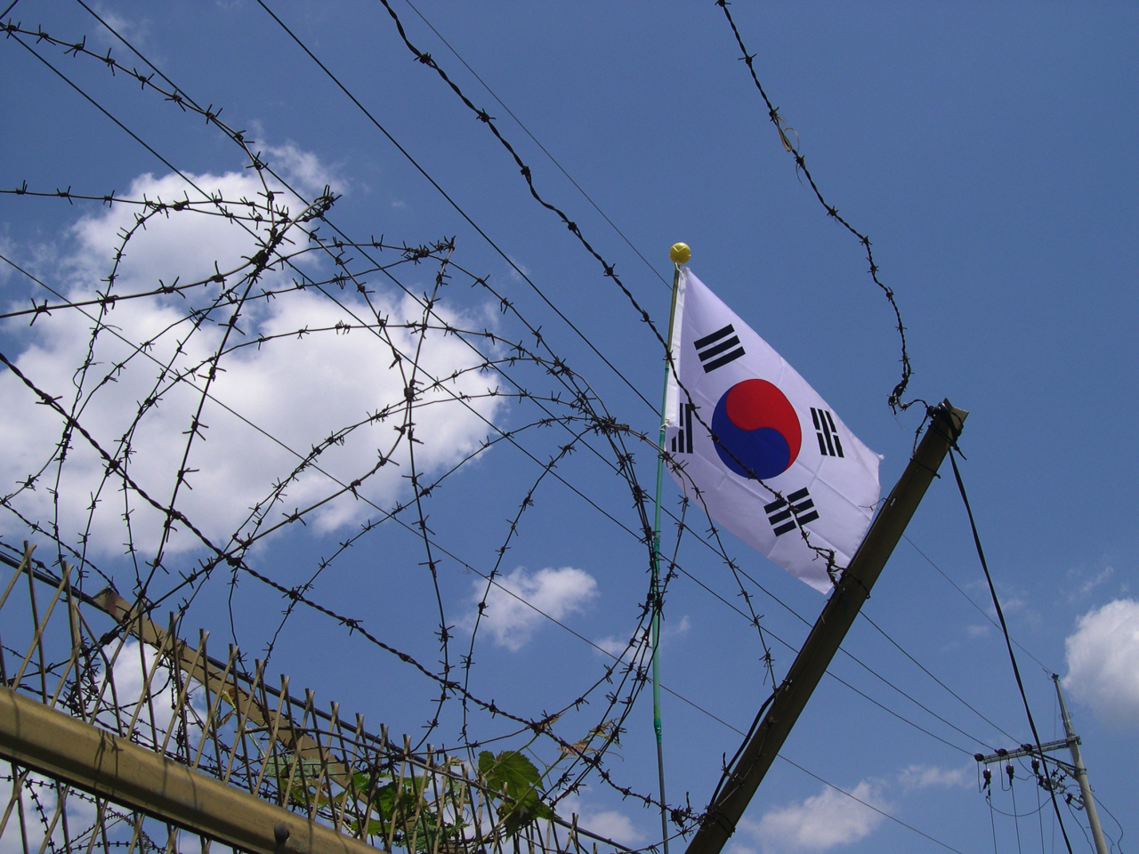 Korean flag seen through barbed wire at the DMZ, Panmunjeom, South Korea. (Getty Images Bank)
