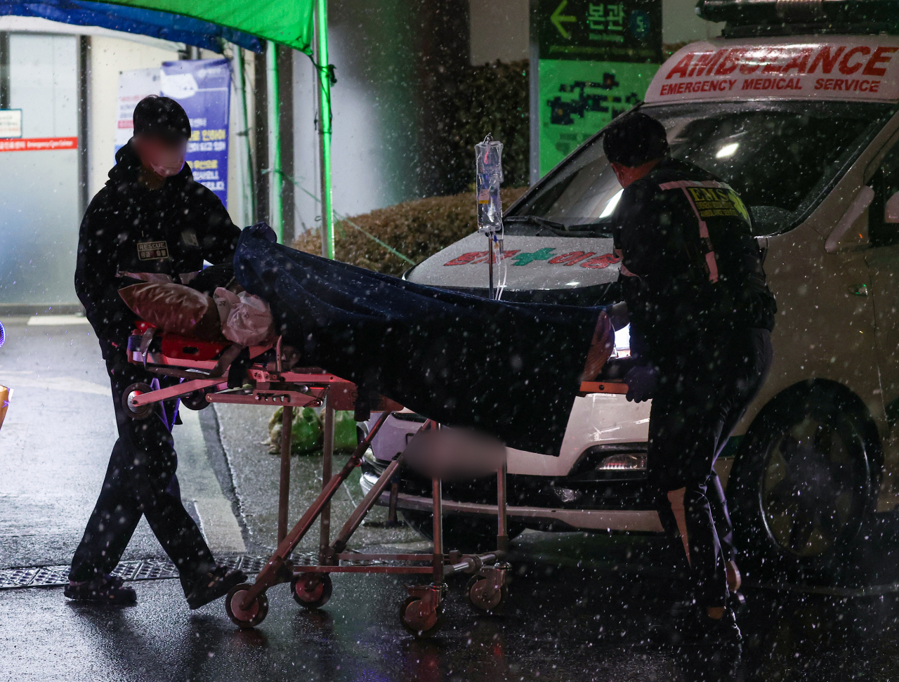 Medical personnel transport a patient in front of an emergency room at a hospital in Seoul, Wednesday. (Yonhap)