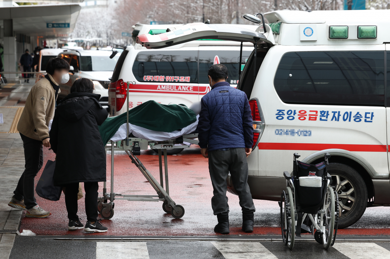 A patient is carried to an ambulance at a general hospital in Seoul on Thursday, to be transferred to another hospital amid an ongoing strike by trainee doctors. (Yonhap)