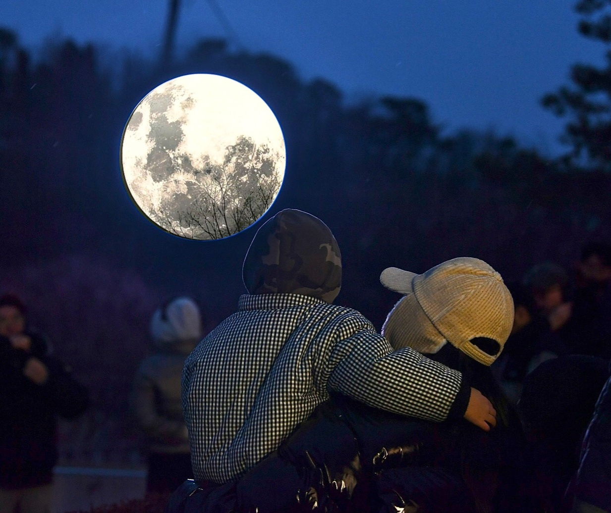Visitors enjoy moon-shaped light fixture during Aegibong Moonlight Light Show at Aegibong Peace Ecopark on Saturday. (Gimpo City)
