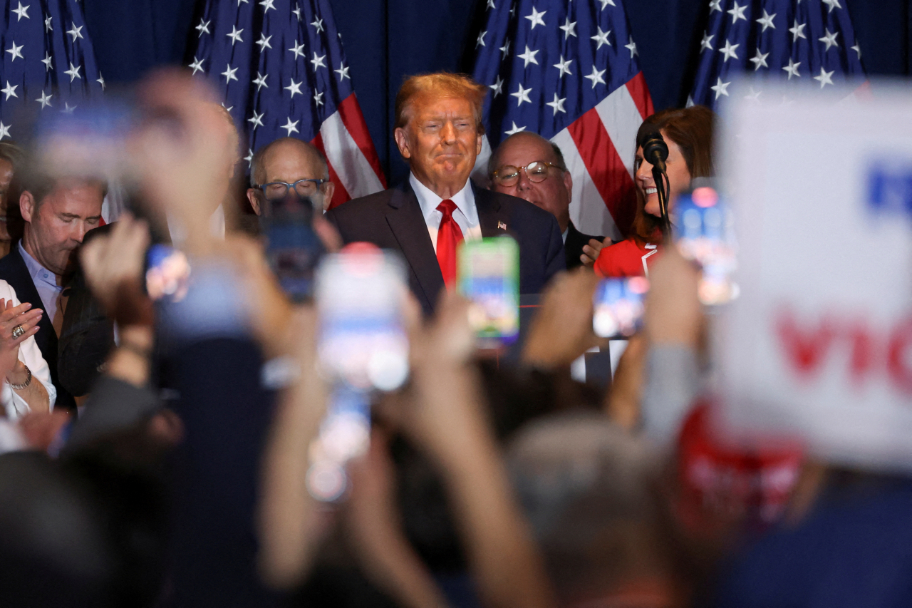 Republican presidential candidate and former US President Donald Trump stands on stage as he hosts a South Carolina Republican presidential primary election night party in Columbia, South Carolina, Saturday. (Reuters-Yonhap)