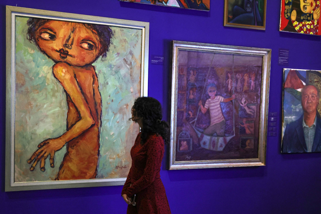 A person visits the 'This Is Not An Exhibition' section displaying paintings by Gazan artists, as the Palestinian Museum reopened in Birzeit town in the occupied West Bank on February 11, 2024. (AFP-Yonhap)