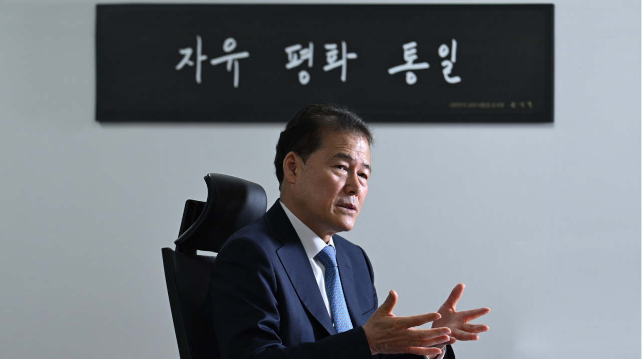 South Korean Unification Minister Kim Yung-ho speaks during an exclusive interview with The Korea Herald on Friday at his office in Seoul, where framed calligraphy of President Yoon Suk Yeol's mantra. (Im Se-jun/ The Korea Herald)