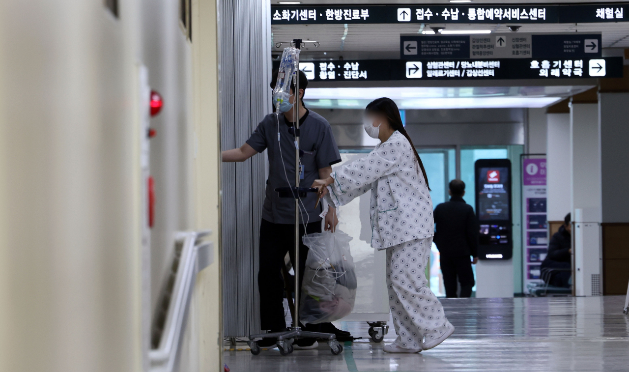 A patient walks at a hospital in Seoul. (Yonhap)