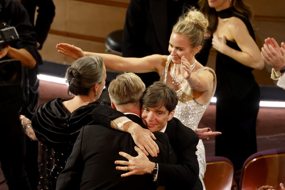 Cillian Murphy (the second from right) embraces Christopher Nolan as Emily Blunt (right) reaches for Emma Thomas after the film Oppenheimer won the Oscar for Best Picture during the 96th annual Academy Awards ceremony at the Dolby Theatre in the Hollywood neighborhood of Los Angeles, California, Sunday. (EPA-Yonhap)