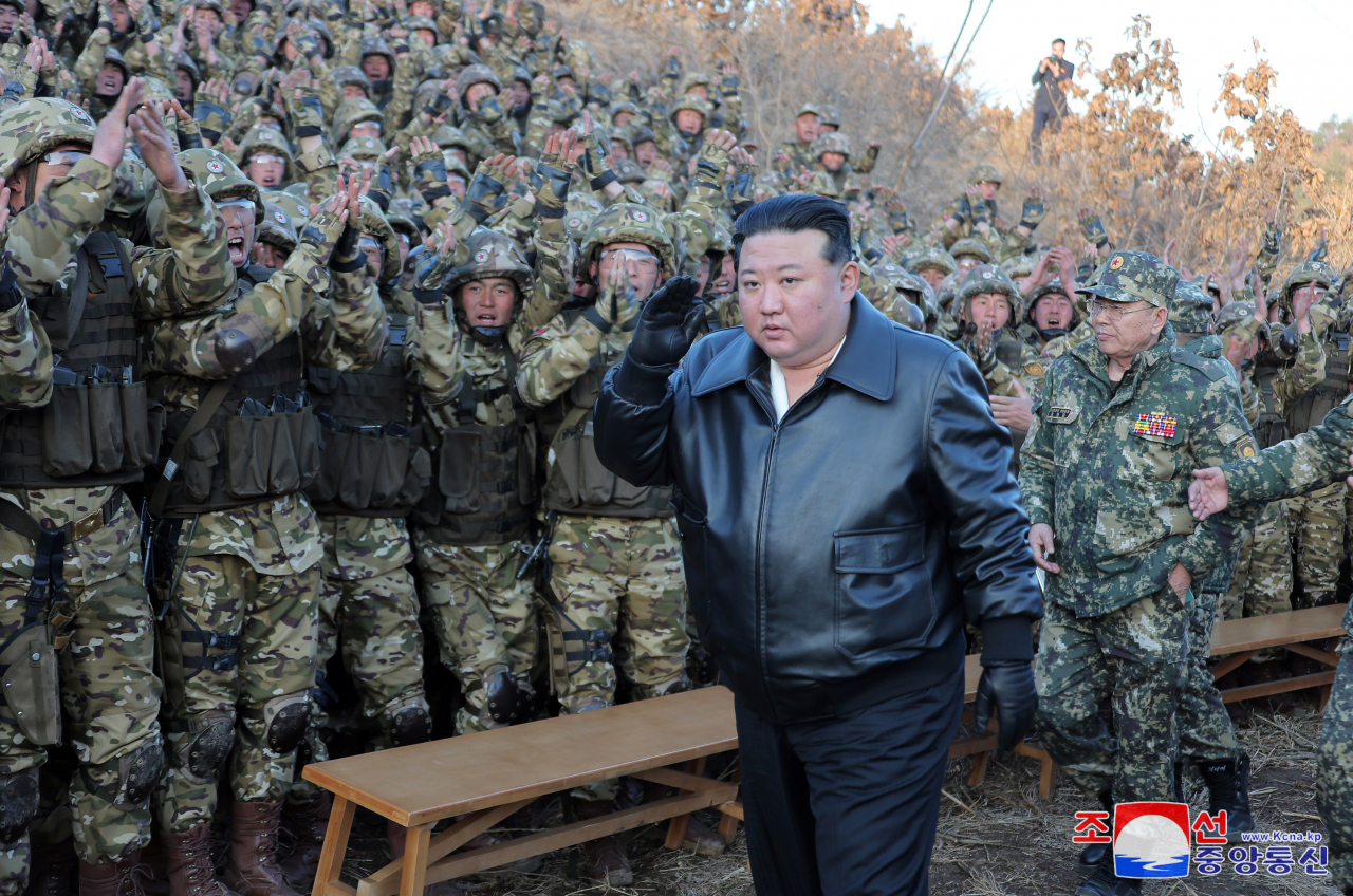 North Korean leader Kim Jong-un (in leather jacket) inspects a drill during a visit to a major operational training base in the country's western region on Wednesday. (KCNA)