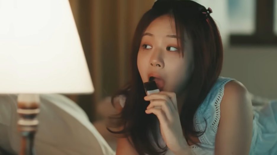 K-pop singer Bibi eats Korean sweet chestnut jelly, yanggaeng, in a music video for 
