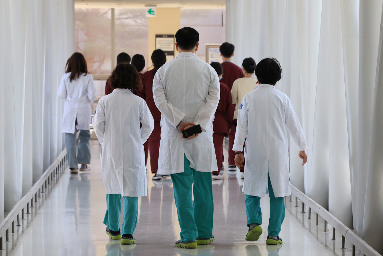 Medical workers walk at a university hospital in Seoul, on Thursday. (Yonhap)