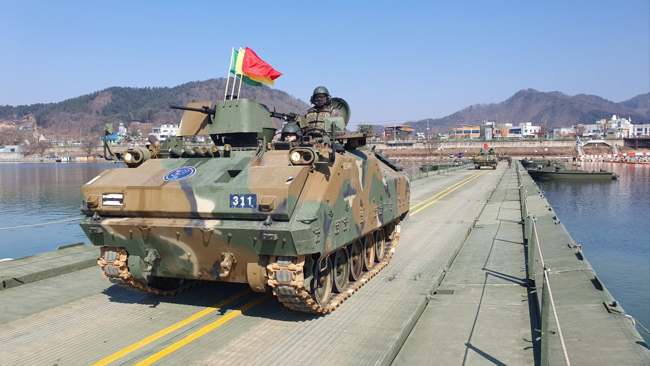 An armored tank crosses a makeshift bridge during river-crossing drills held in Hwacheon, 89 kilometers northeast of Seoul on March 13, 2024. (Korean Army 3rd Corps)