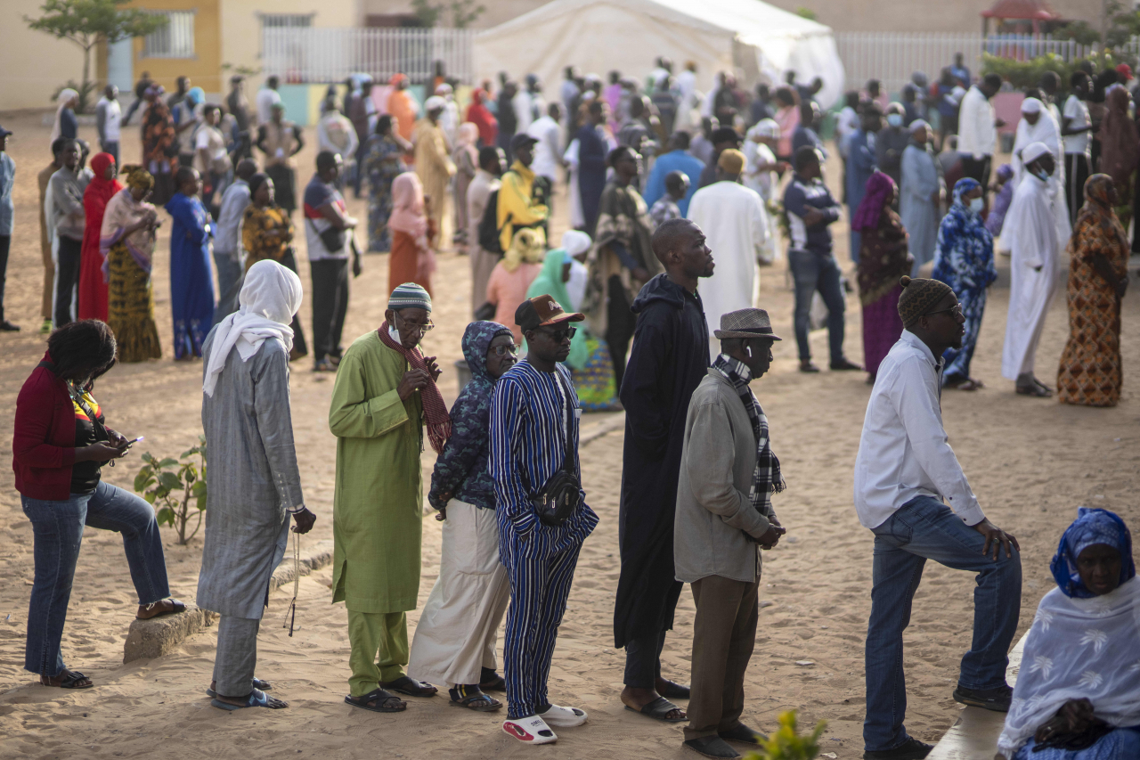 People wait to cast their votes outside a polling station during the presidential elections, in Dakar, Senegal, Sunday. (AP)