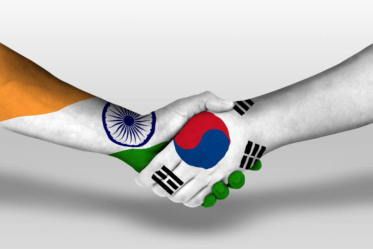The national flags of India (left) and South Korea are embedded within images of shaking hands. (123rf)