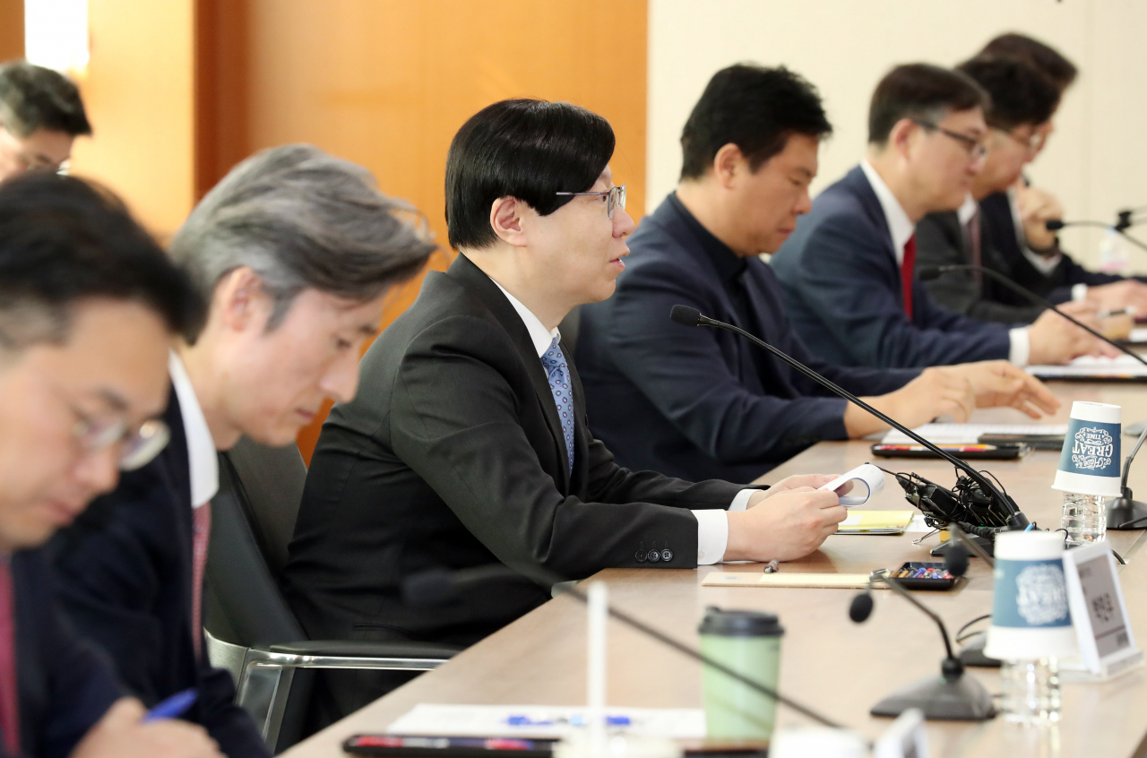 Financial Services Commission Vice Chairman Kim So-young (third from left) speaks during a meeting about 