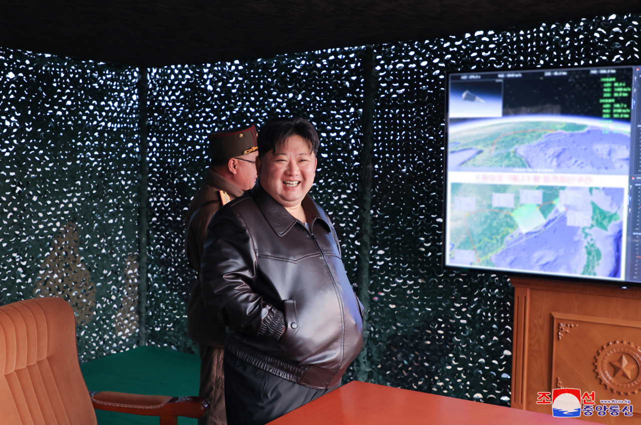 North Korean leader Kim Jong-un (right) smiles while inspecting the launch of a Hwasongpho-16B, a new type of intermediate-range solid-fueled ballistic missile equipped with a newly-developed hypersonic gliding warhead, on April 2, 2024, in this photo released by the North's official Korean Central News Agency the following day. (Yonhap)