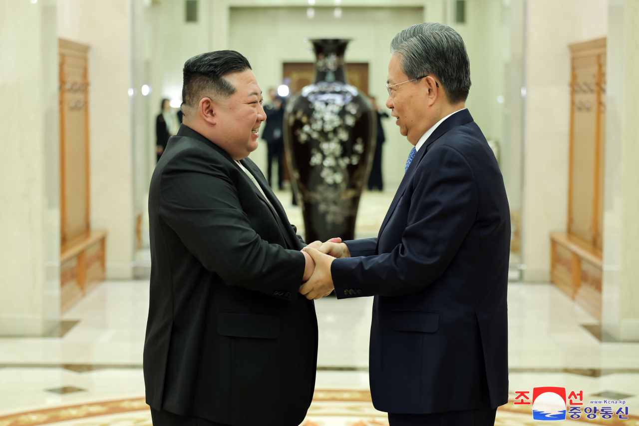 This photo shows North Korean leader Kim Jong-un (Left) meeting with Zhao Leji, chairman of the Standing Committee of the National People's Congress of China, in Pyongyang on Saturday. (KCNA)