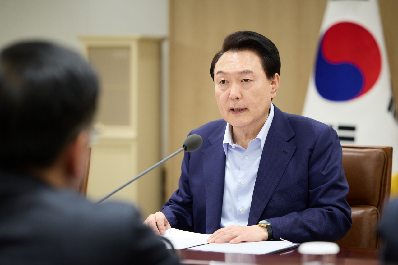 President Yoon Suk Yeol (right) speaks during an emergency cabinet meeting to discuss government measures against the rising Middle East conflict held at the presidential office in Seoul on Sunday. (Yonhap)