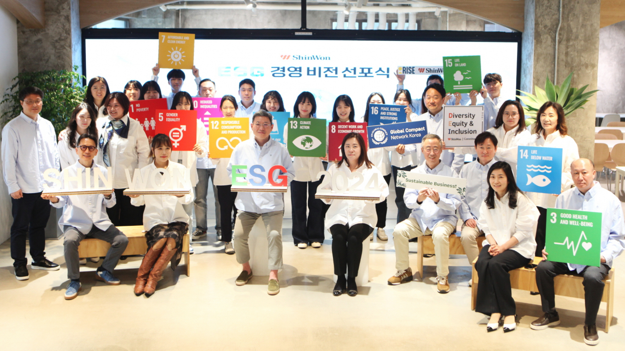 ShinWon Corporation CEO JJ Park (third from left, front row) and employees attend an ESG management vision declaration ceremony held at the firm's headquarters in Seoul in March. (ShinWon Corp.)