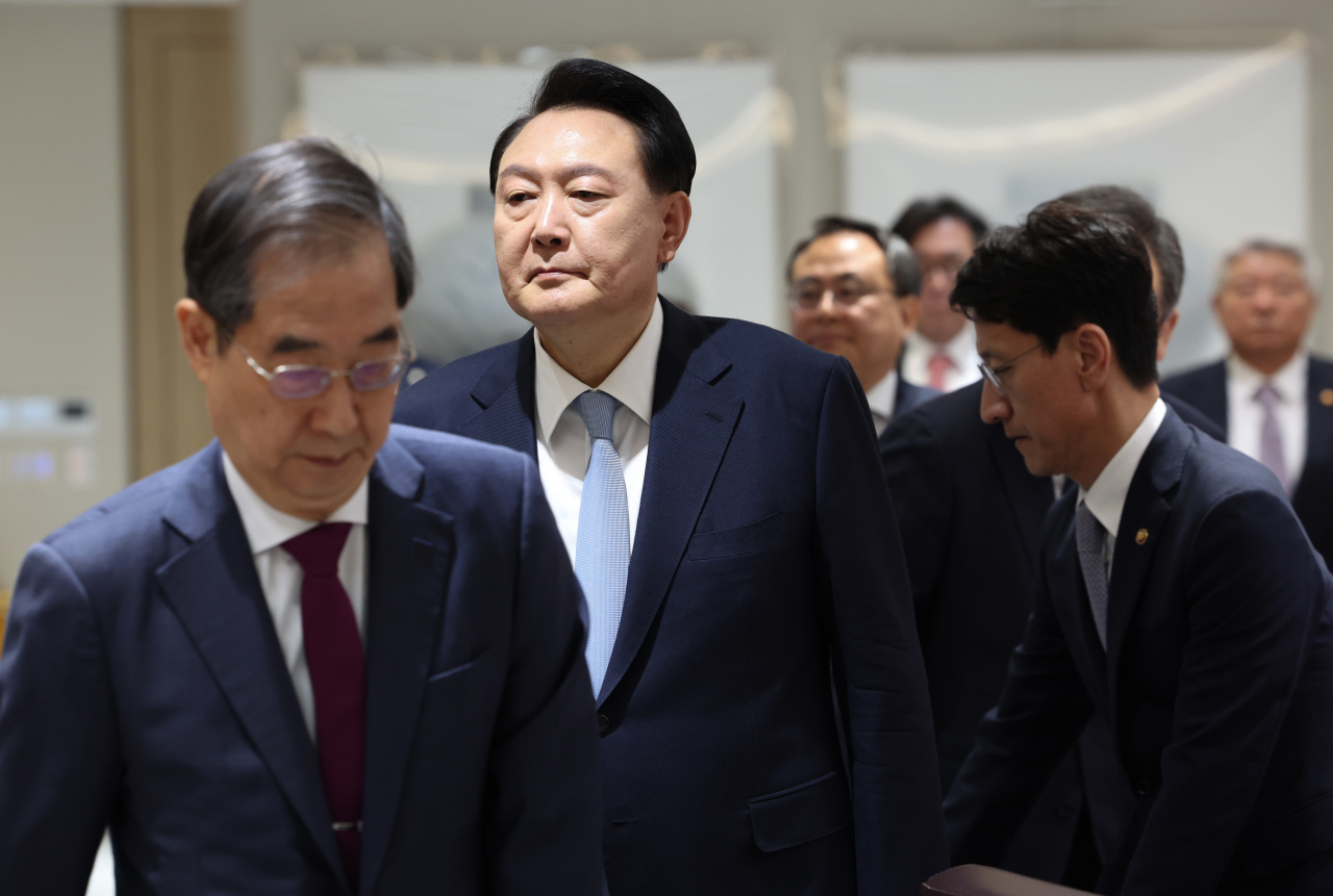 President Yoon Suk Yeol (second from left) enters a Cabinet meeting he presided over in Seoul on Tuesday. (Yonhap)