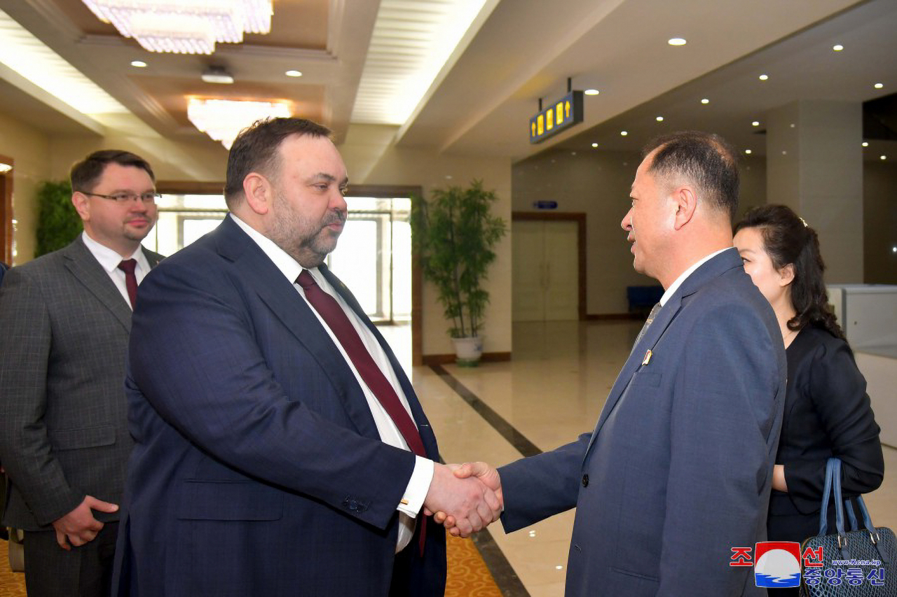 Belarusian Deputy Foreign Minister Evgeny Shestakov (left) shakes hands with a North Korean official after arriving in Pyongyang on Tuesday, in this photo released by the Korean Central News Agency the following day. (Yonhap)