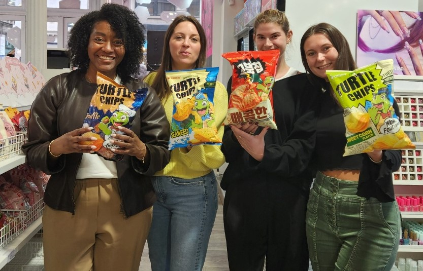 US customers hold Orion's Turtle Chips at a Miniso store in the US. (Orion)