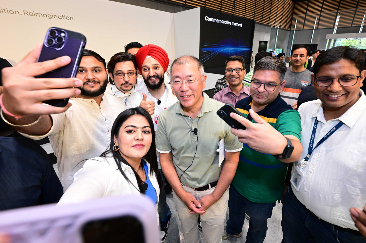 Hyundai Motor Group Executive Chair Chung Euisun (center) takes photos with local employees at the automaker's Indian headquarters in Gurgaon on Tuesday. (Hyundai Motor Group)