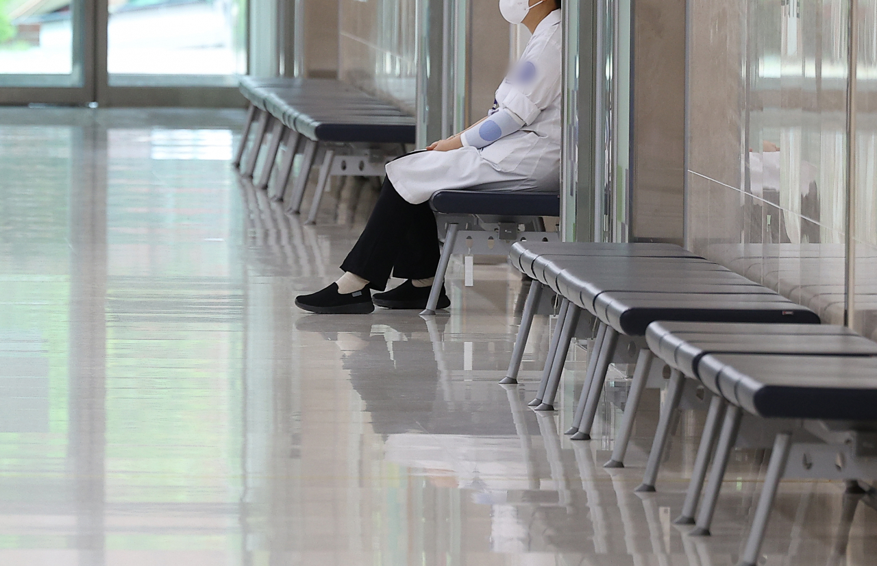 Amid the ongoing standoff between doctors and the government, a doctor sits in a hospital in Daegu on Friday. (Yonhap)