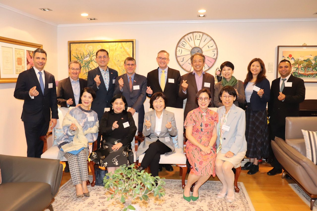 Attendees pose for a group photo at Korea CQ Forum at the residence of Singapore Ambassador in Seongbuk-gu, Seoul, on Tuesday. (CICI)