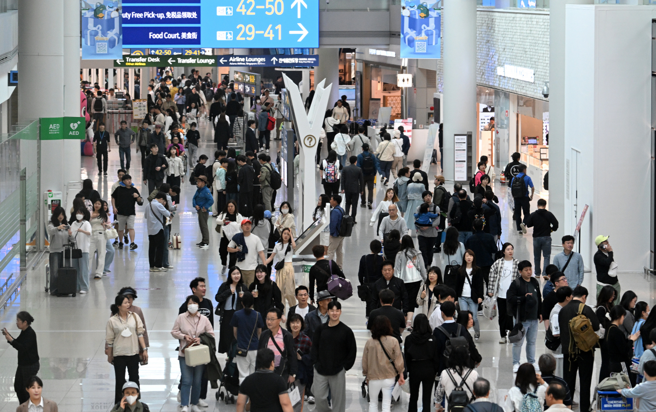 Incheon International Airport's Terminal 1 bustles with travelers on Friday ahead of the Children's Day holiday season. (Im Se-jun/The Korea Herald)