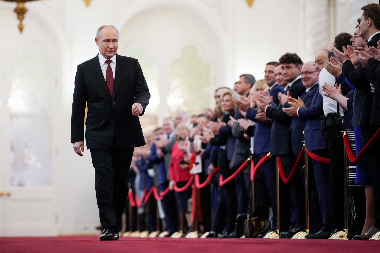 Russian president-elect Vladimir Putin walks prior to his inauguration ceremony at the Kremlin in Moscow on Tuesday. (AFP-Yonhap)