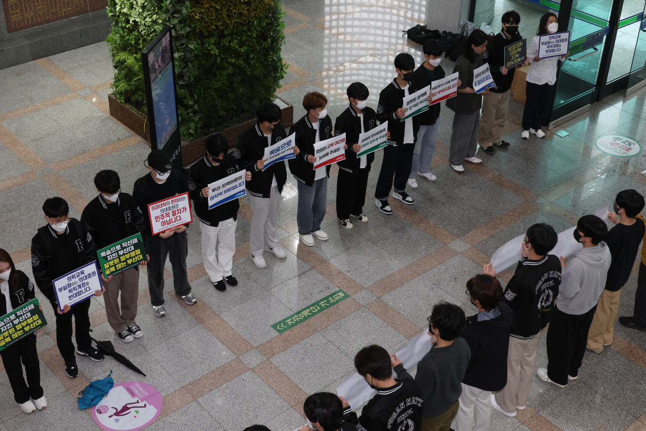 Medical students of Pusan National University protest the school's medical school quota hike plan in a collective action on the campus on May 7, 2024. (Yonhap)