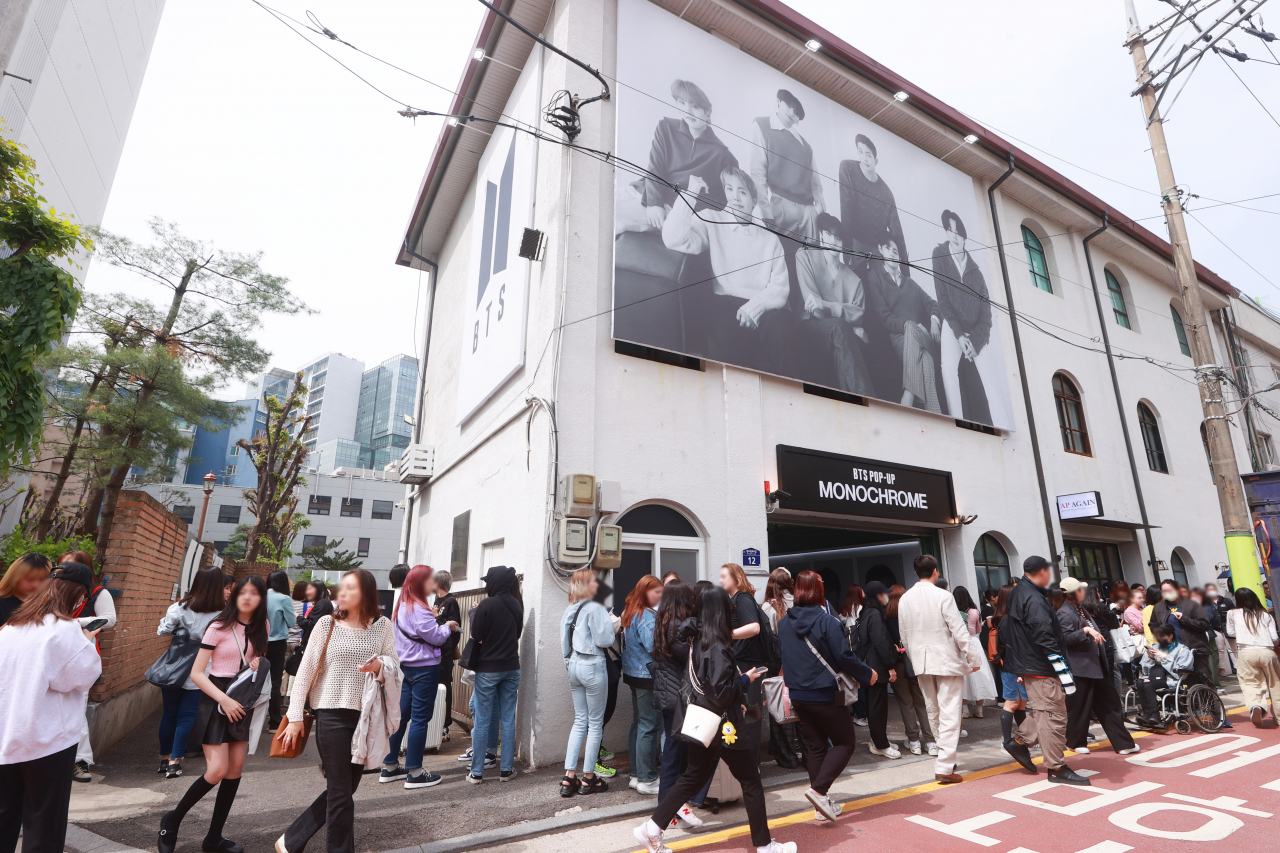 Fans wait in line to enter the BTS pop-up store, 