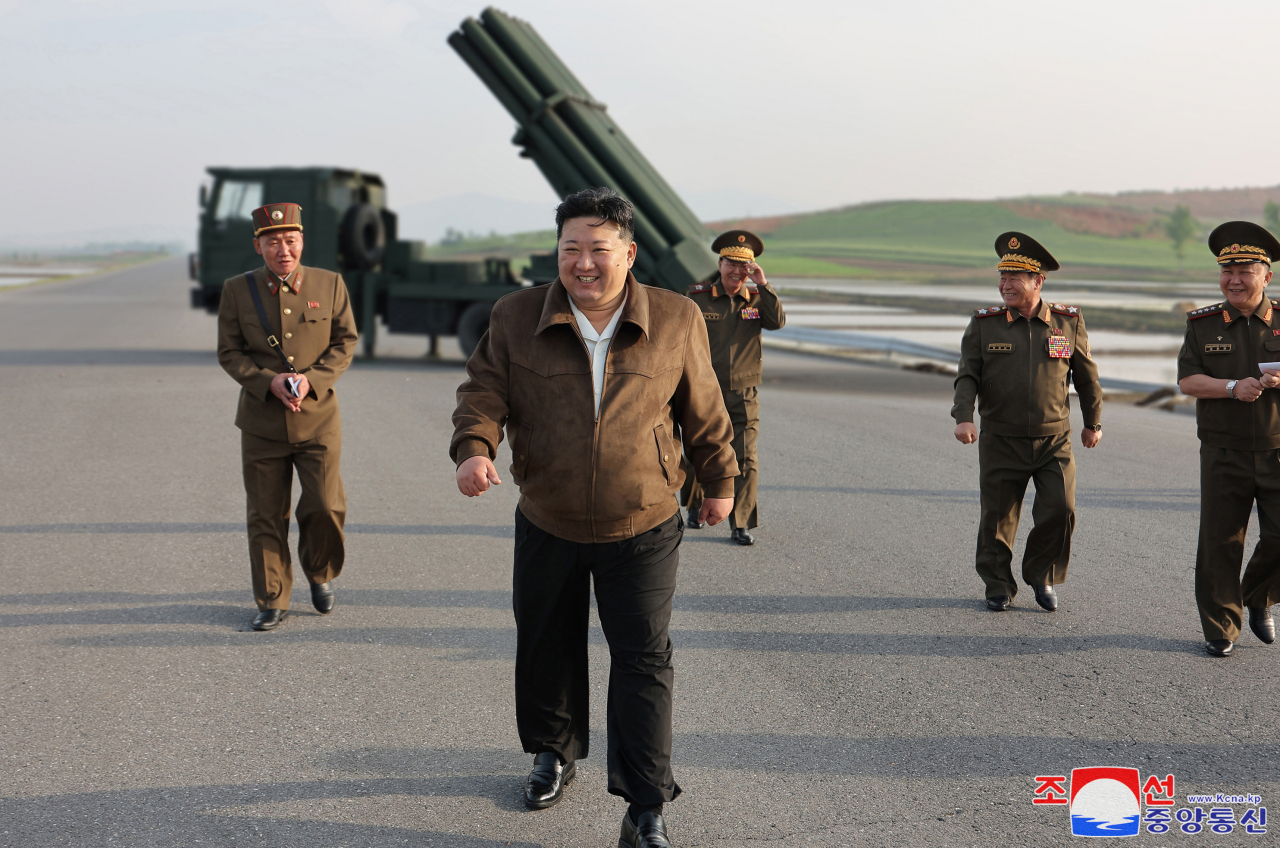 This photo, carried by North Korea's official Korean Central News Agency on May 11, shows the North's leader Kim Jong-un inspecting a test-firing of controllable shells for an advanced 240mm multiple rocket launcher the previous day. (Yonhap)