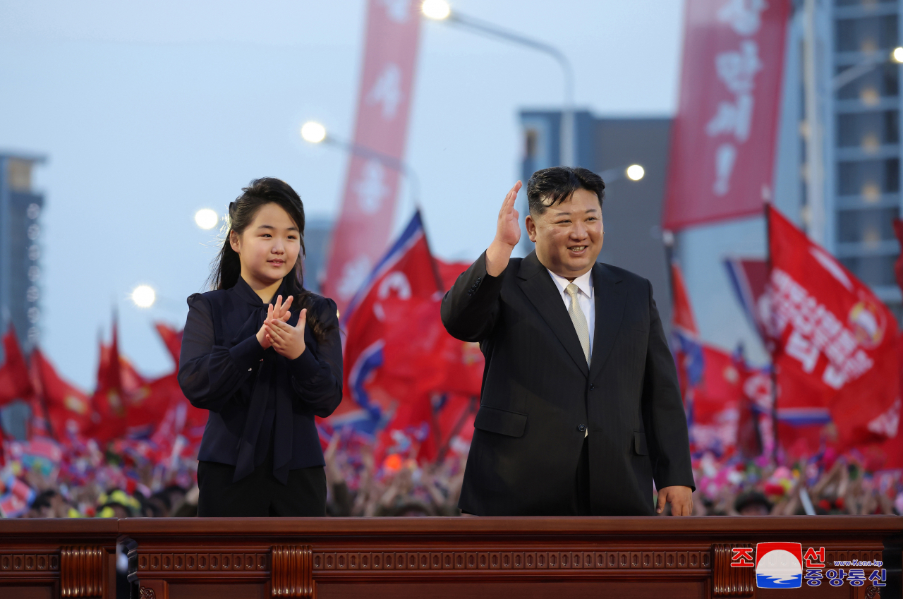 North Korean leader Kim Jong-un (right) attends a ceremony alongside his daughter, Ju-ae, to mark the completion of a new street in Pyongyang on Tuesday. (KCNA)