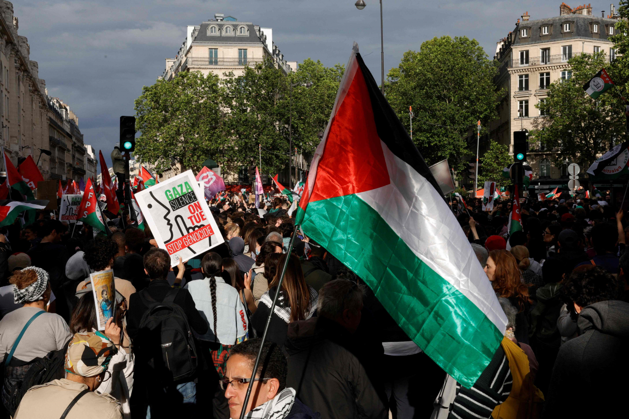 A protestor holds a Palestinian flag during a demonstration called by the French organization 