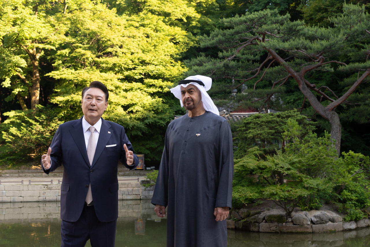 President Yoon Suk Yeol (L) and United Arab Emirates President Mohamed bin Zayed Al Nahyan walk inside Changdeok Palace in Seoul on Tuesday, in this photo provided by the presidential office.