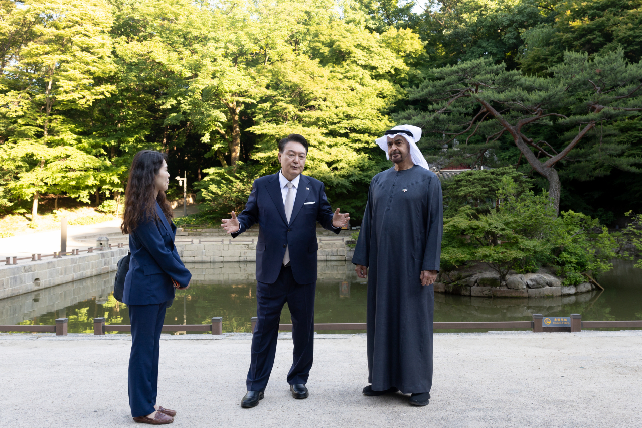 President Yoon Suk Yeol and United Arab Emirates President Mohamed bin Zayed Al Nahyan walk inside Changdeok Palace in Seoul on Tuesday, and First Lady Kim Keon Hee joins the two in this photo provided by the presidential office.