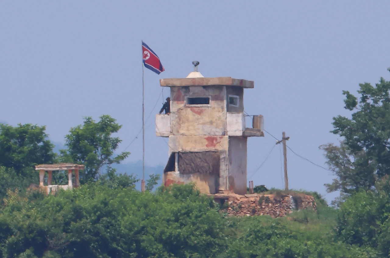 A North Korean soldier stands guard at a post as seen from the border area of Paju, Gyeonggi Province, on the day the South Korean government decided to resume loudspeaker broadcasts across the shared border on Sunday. (Yonhap)