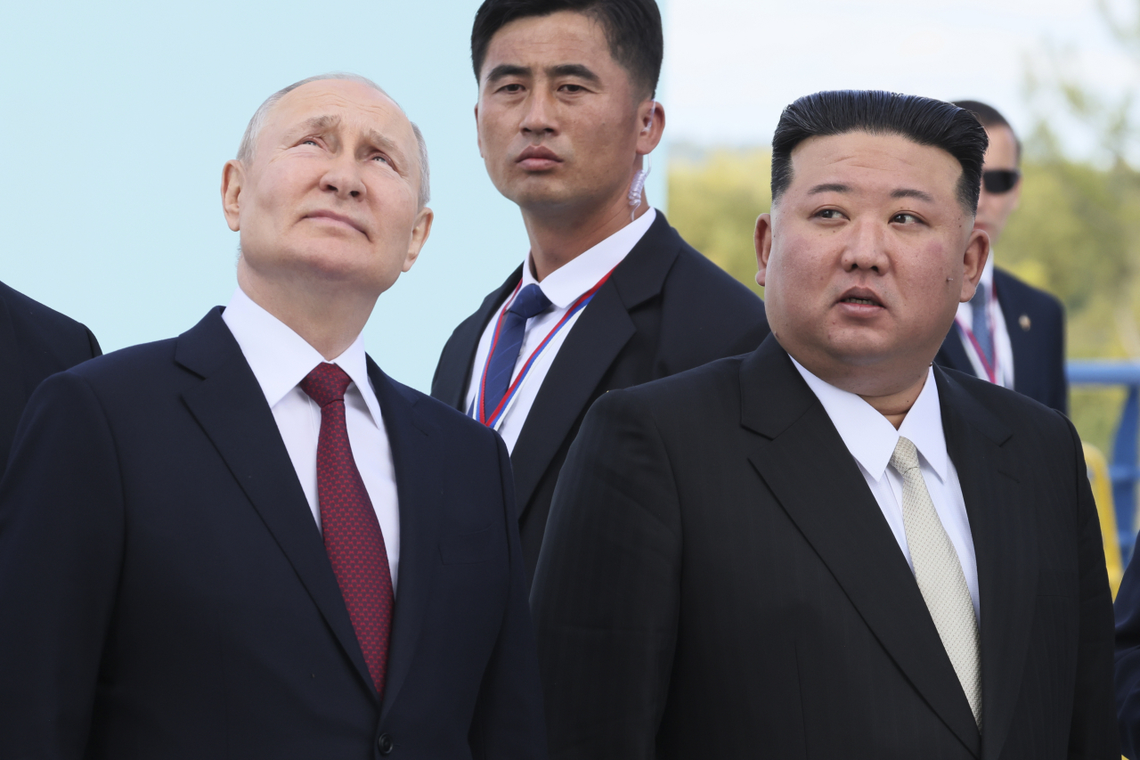 Russian President Vladimir Putin (left) and North Korea's leader Kim Jong Un examine a launch pad of Soyuz rockets during their meeting at the Vostochny Cosmodrome outside the city of Tsiolkovsky, about 200 kilometers (125 miles) from the city of Blagoveshchensk in the far eastern Amur region, Russia, on Wednesday, Sept. 13, 2023. (Kremlin Pool Photo via AP)