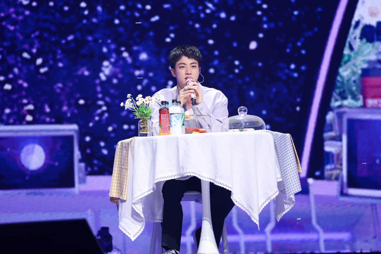 Jin speaks during the mukbang session at his fan-meeting event at Jamsil Arena, Seoul, Thursday. (Big Hit Music)