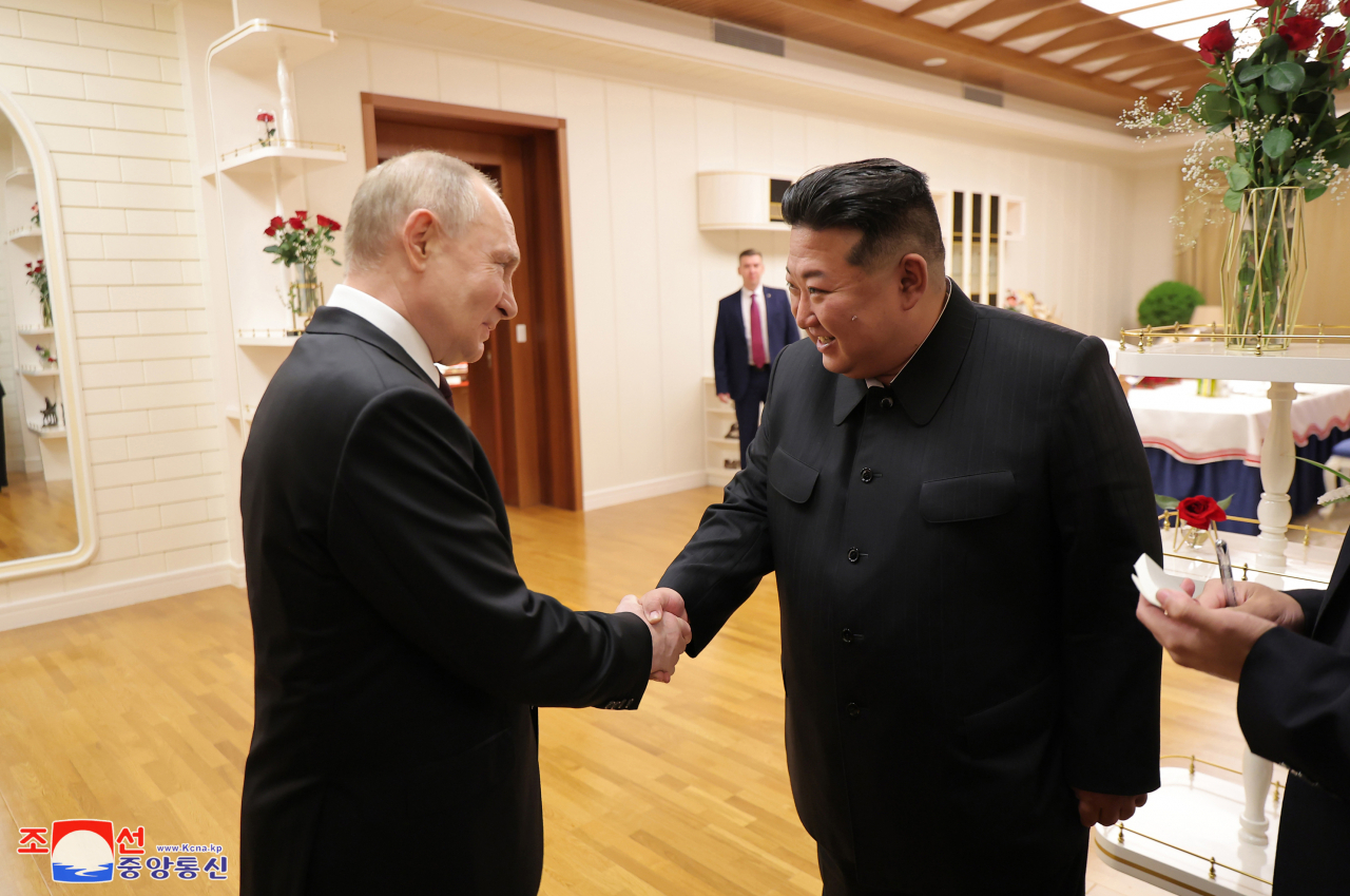 North's leader Kim Jong-un (right) greeting Russian President Vladimir Putin (left), who arrived in Pyongyang on Wednesday for a state visit. (KCNA)