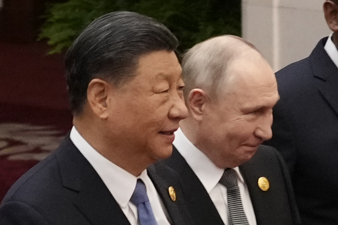 Chinese President Xi Jinping (left) and Russian President Vladimir Putin prepare for a group photo with other leaders at the Third Belt and Road Forum on October 2023 in Beijing, China. (Getty Images)