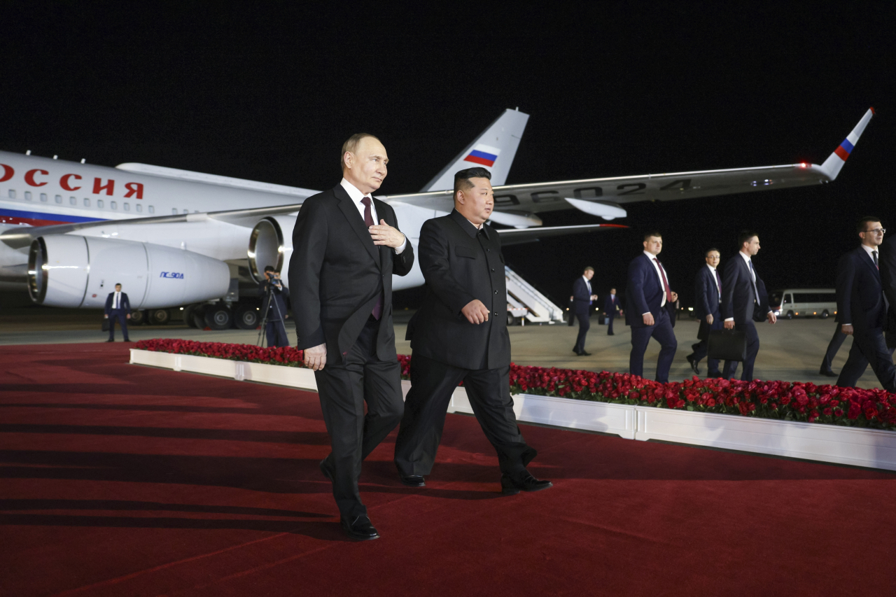 Russia's President Vladimir Putin (left) and North Korean leader Kim Jong-un are seen at the airport on Wednesday. (Kremlin via TASS)