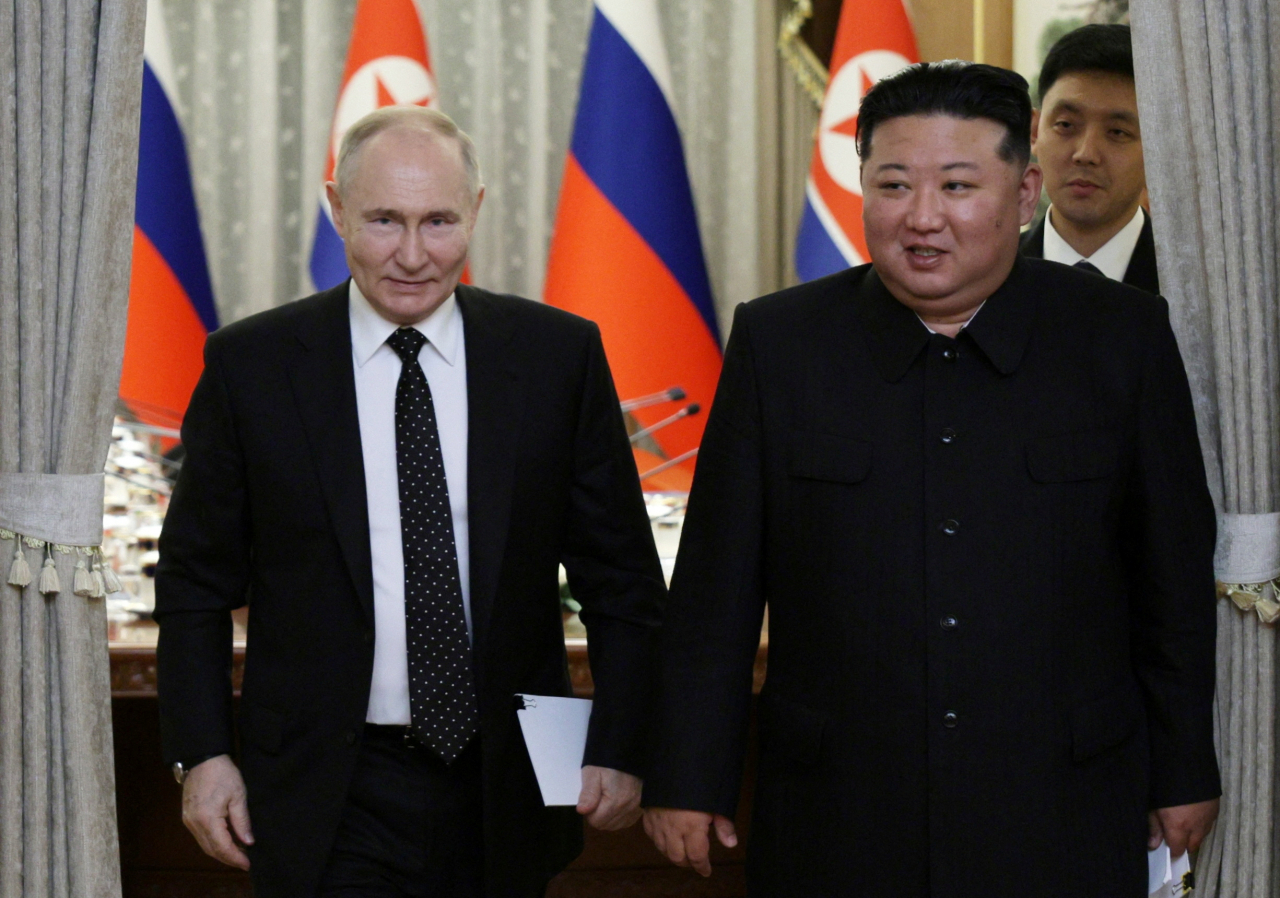 Russia's President Vladimir Putin (left) and North Korea's leader Kim Jong Un attends a meeting in Pyongyang on Wednesday (Pool Photo via Reuters)