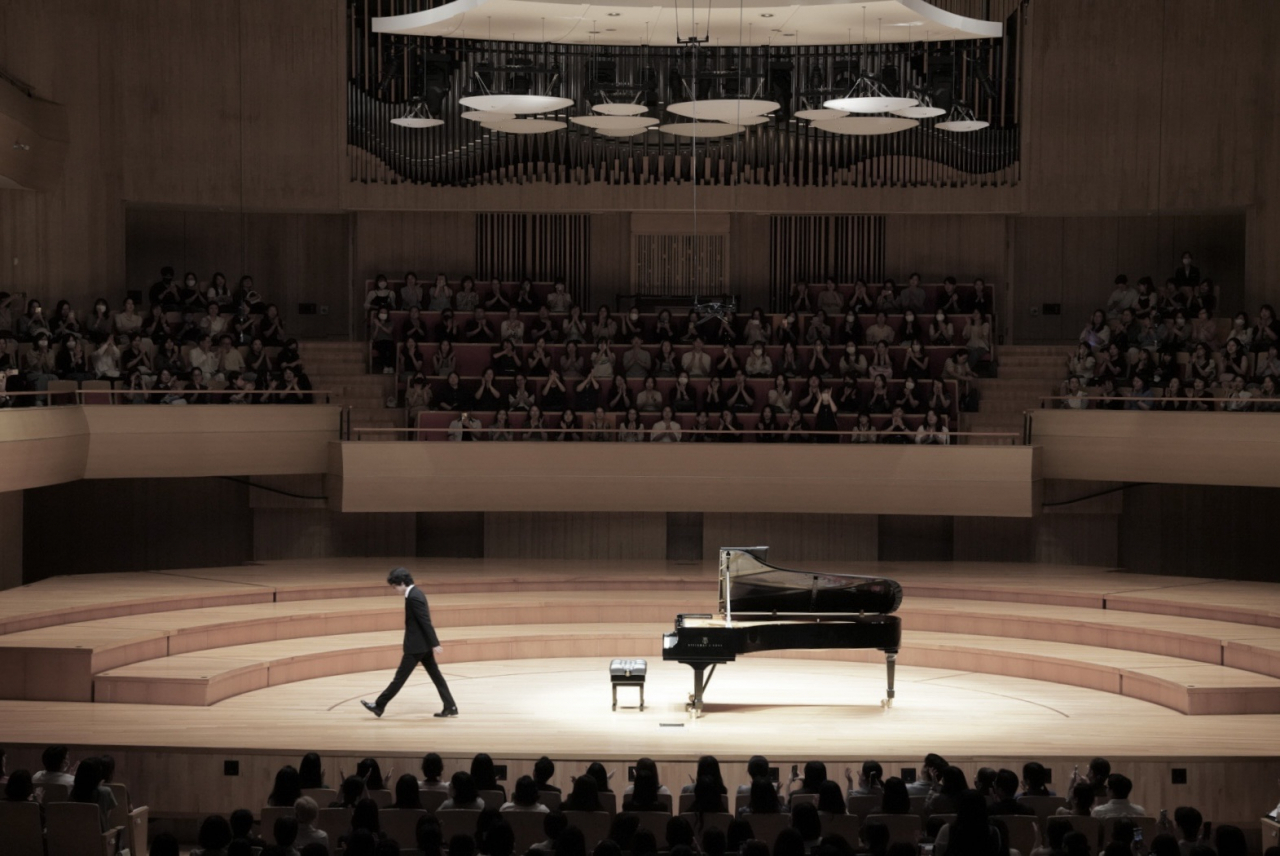 Yunchan Lim walks to the end of the stage after the first part of his recital at the Bucheon Art Center on Monday. (Bucheon Art Center)