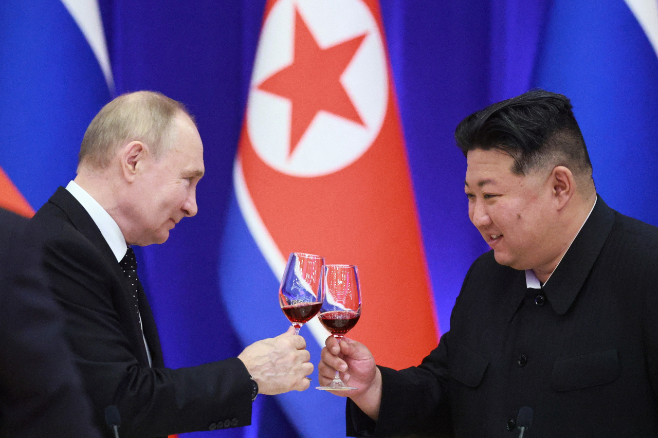 Russia's President Vladimir Putin (left) and North Korea's leader Kim Jong Un attend a state reception in Pyongyang on June 19, 2024. (Pool via Reuters)