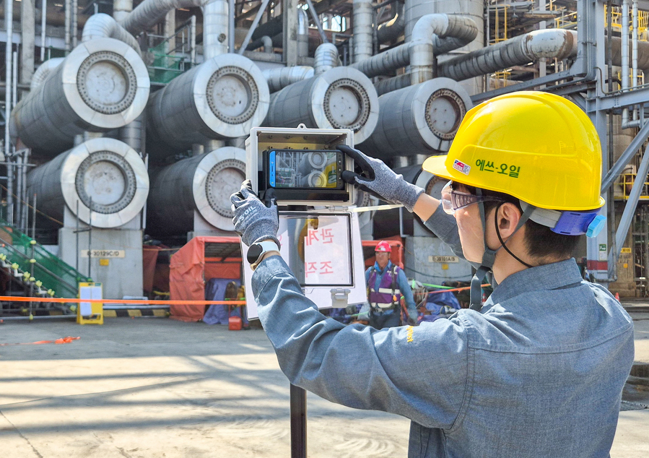A worker is setting up a portable CCTV system at S-Oil's Onsan plant in Ulsan (S-Oil)