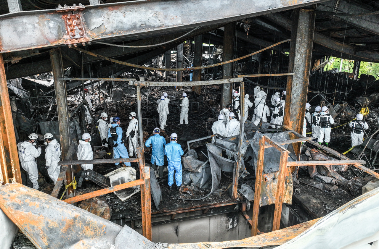 Police, firefighters and forensic officials jointly conduct an investigation at the lithium battery plant in Hwaseong, 45 kilometers south of Seoul, on Tuesday to determine the cause of the fire that broke out on Monday. (Yonhap)