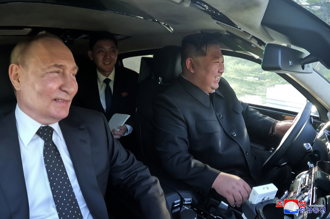 Russian President Vladimir Putin and North Korean leader Kim Jong-un share a limousine ride in Pyongyang, North Korea. (Yonhap-Korean Central News Agency)