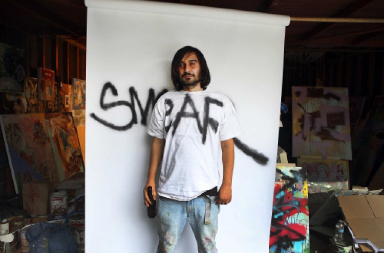 Graffiti artist puts tagging behind him