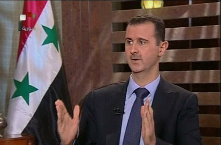 Assad warns against foreign intervention