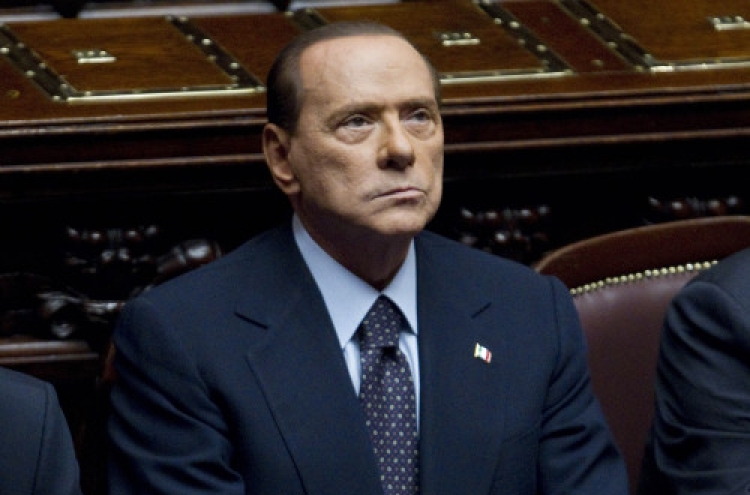 Defiant Berlusconi taken down by markets